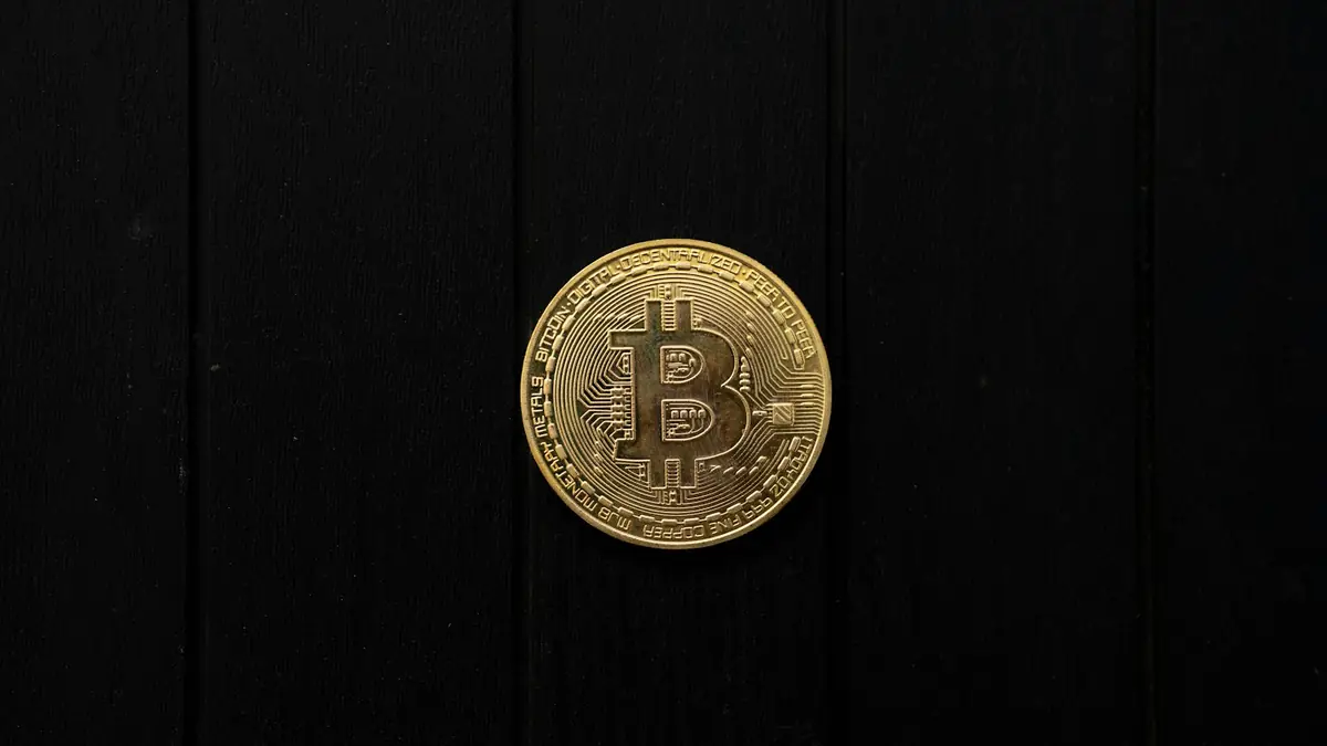 Gold Bitcoin coin on a black background